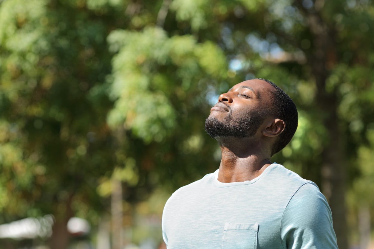 Man breathing fresh air on green park