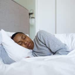 Serene woman sleeping soundly in comfortable bed